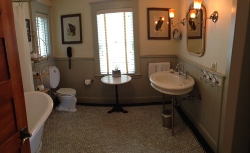 Our bathroom, a nice blend of the updated (that floor may look old-fashioned but it's heated) and the utterly charming (please note the vintage toilet, sink, and bath — all of which worked with modern efficiency).