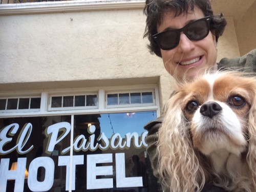 This is the smile of a woman who isn't quite sure that she, her dog, AND the hotel sign are all in the same picture.