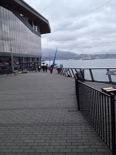 The beginning of the seawall, just below the conference center (that building looming to the left). The cobbles/bricks are the pedestrian path; bikers have a separate, smooth path on the left. The blue sculpture in the distance is called "The Drop."