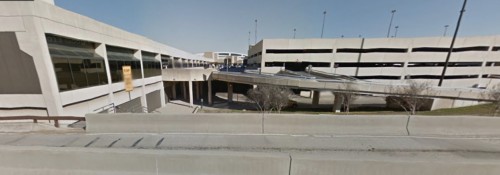 The pet relief area from above — Terminal C parking to the right, Terminal C baggage claim behind and to the lower left