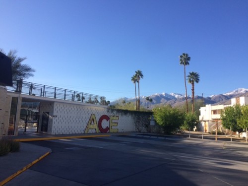 The parking lot behind the porte cochère — chosen to go first because of the big ACE letters, and because we arrived after dark, and those mountains surprised me the next morning